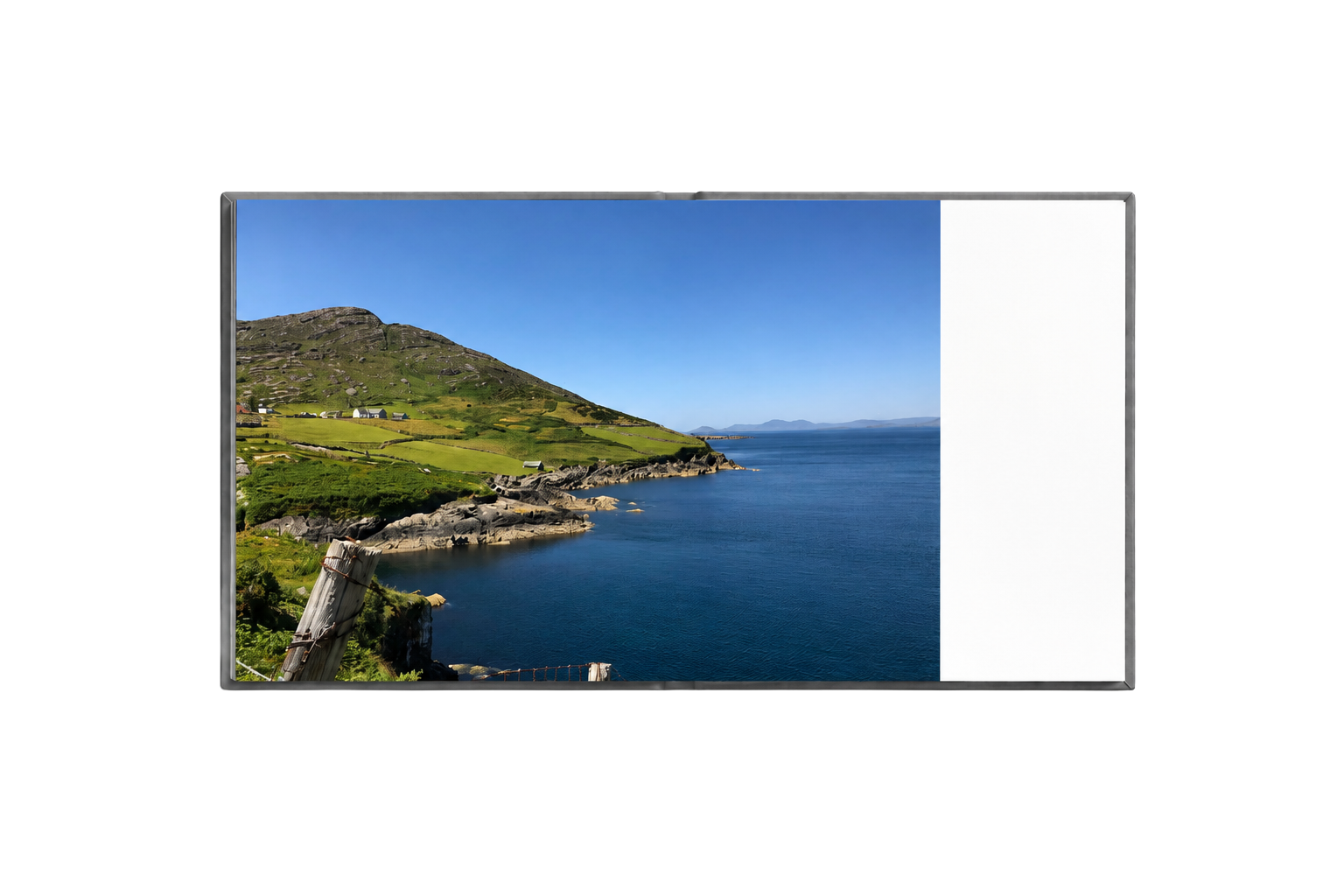 Open Ireland album spread with a coastal landscape photograph